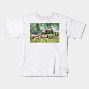 Delicate pink mushrooms on forest floor. Kids T-Shirt